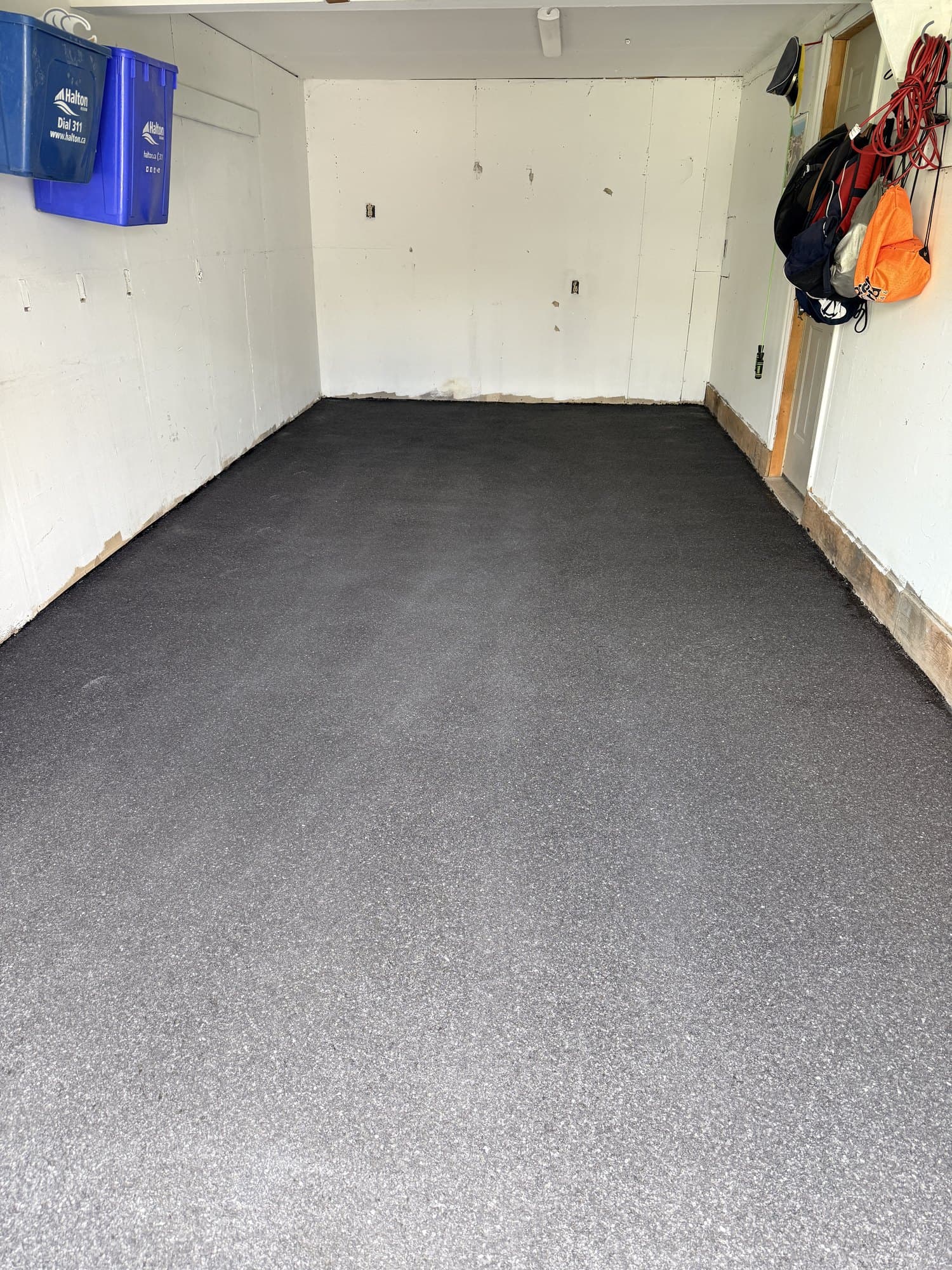 The same garage after installation, finished in charcoal flake epoxy with no visible cracks