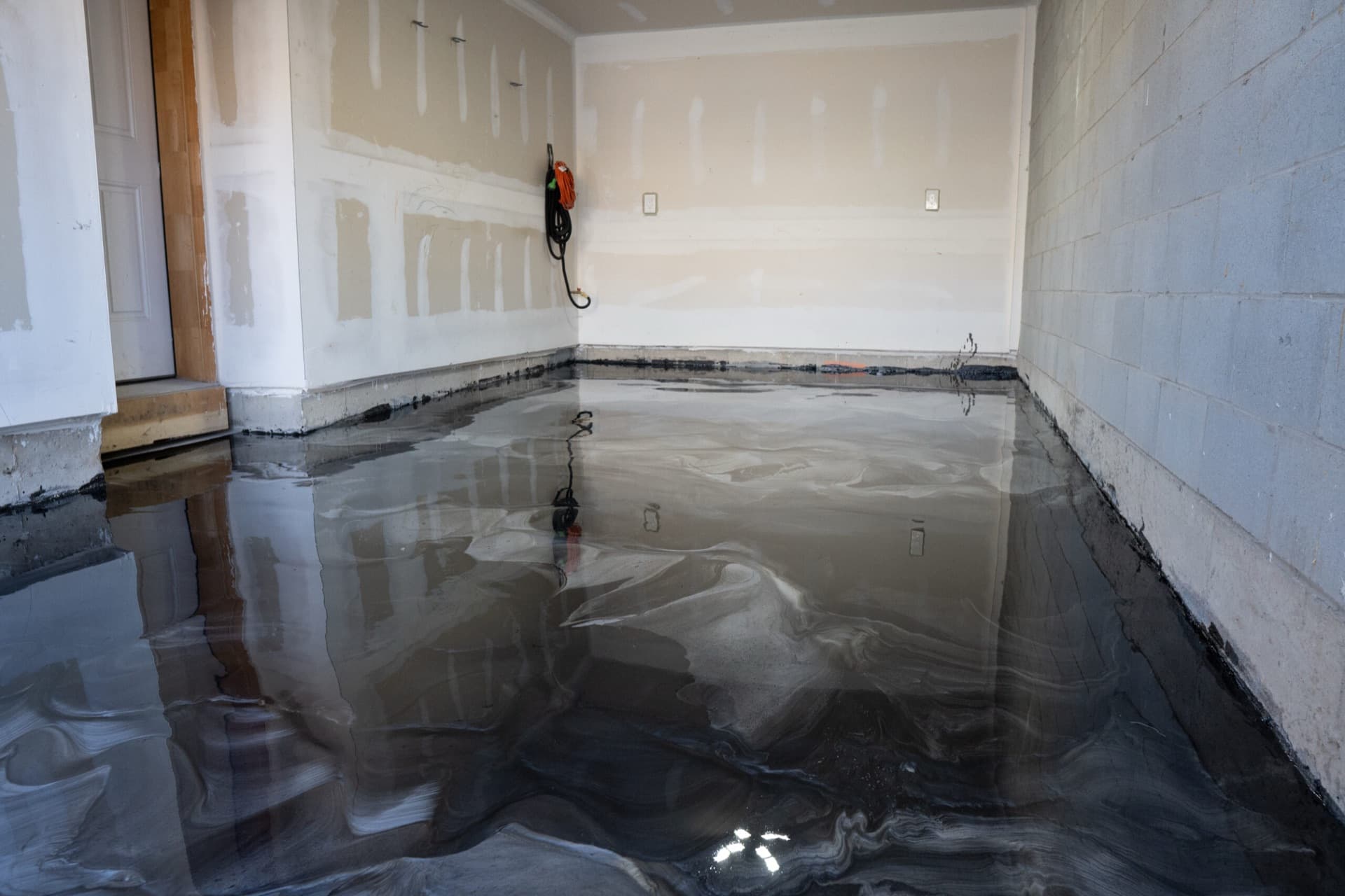 A finished LiquidLux metallic epoxy garage floor of the kind installed for Milton homeowners
