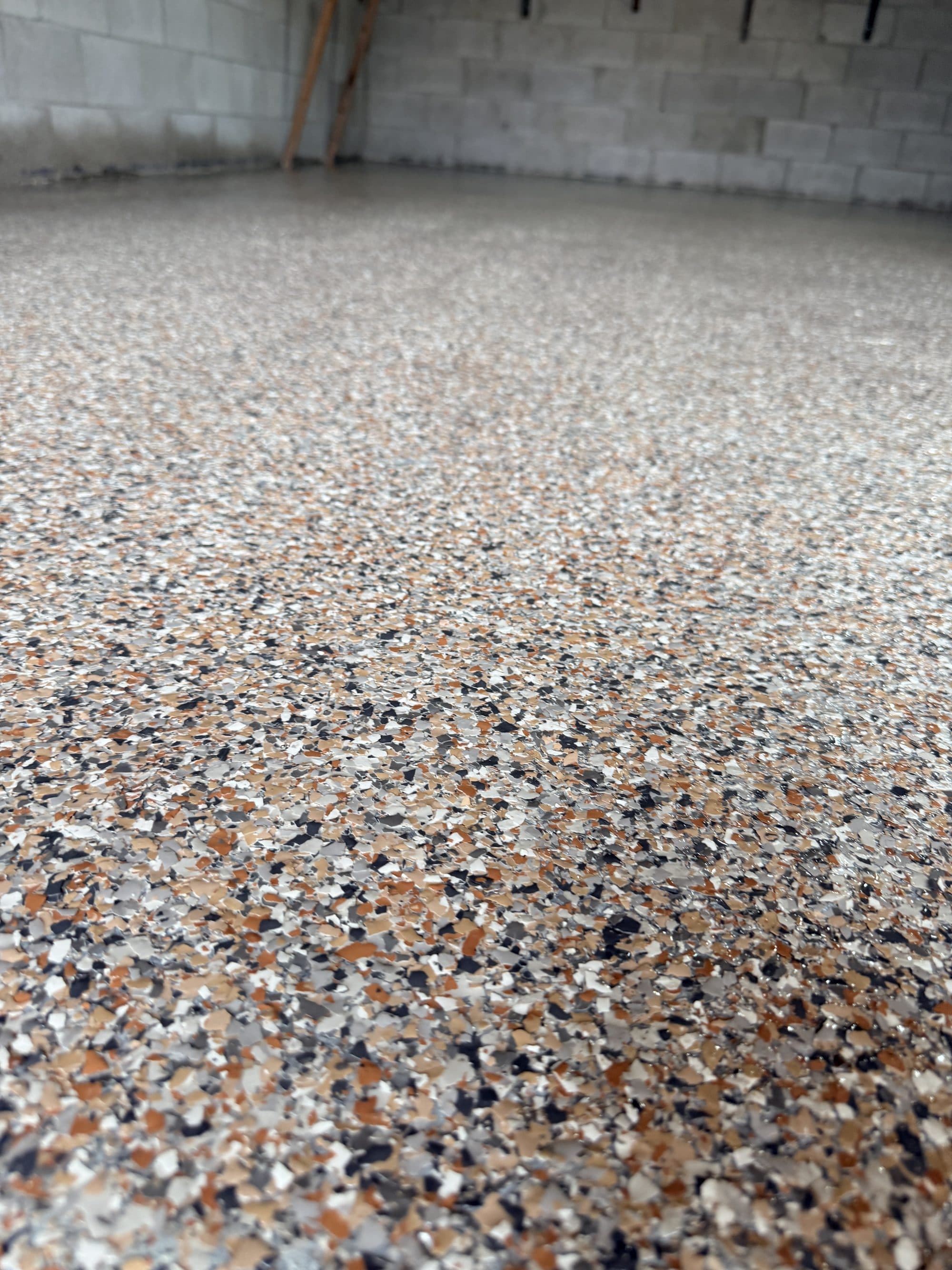 Close detail of the chip broadcast in a finished flake epoxy floor