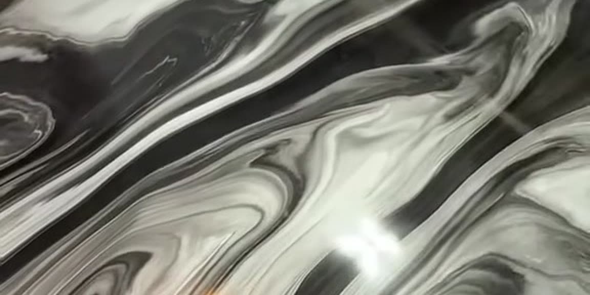 The marbled black-and-white metallic pour LiquidLux uses on countertop and floor work